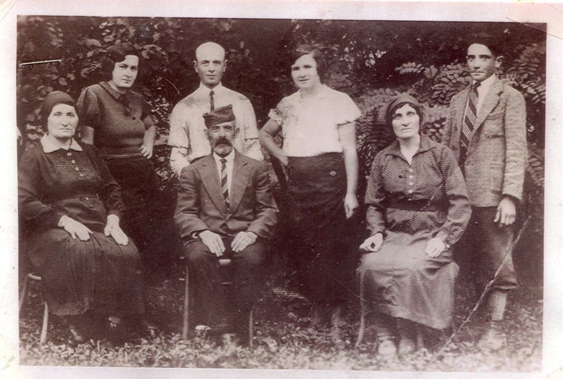 Frida Weiss’ family in 1943. The family asked a neighbor to keep the photograph when they were deported, and it was returned to them after liberation. Standing: Frida and her siblings: Herman, Esther, and Yukshea. Seated: Frida’s mother, father, and aunt, who were all gassed. Yukshea (Jacob) had a friend who provided him a fake ID, and he escaped. The rest of the family survived the Holocaust.