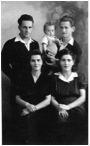 David Naft and Jack Seidner holding baby Leon, standing, with their wives, sisters Lea Slomovic Naft and Sara Slomovic Seidner, 1947.